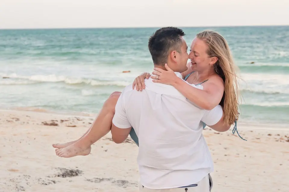 Joe carrying Sophie on the beach